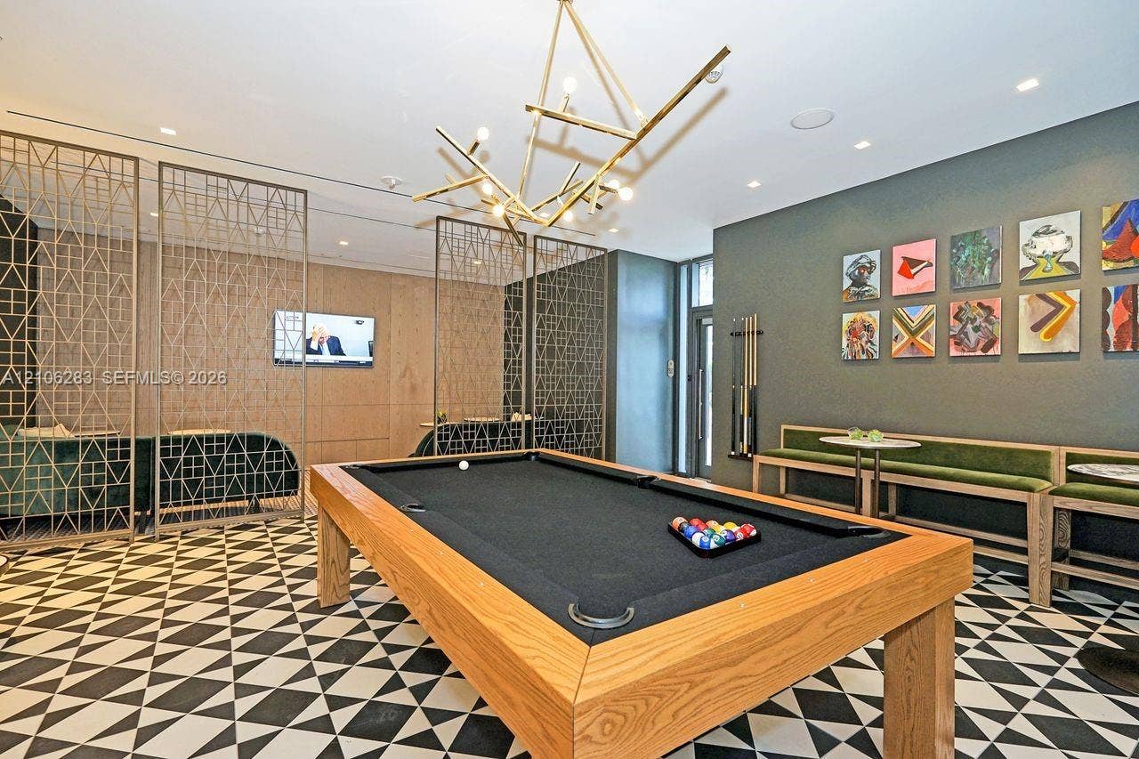 801 S Miami Avenue, #1801, Miami, FL 33130 Geometric patterned tile flooring, intricate metal lattice room dividers, custom wood-finish built-in bench seating, and a statement branching chandelier