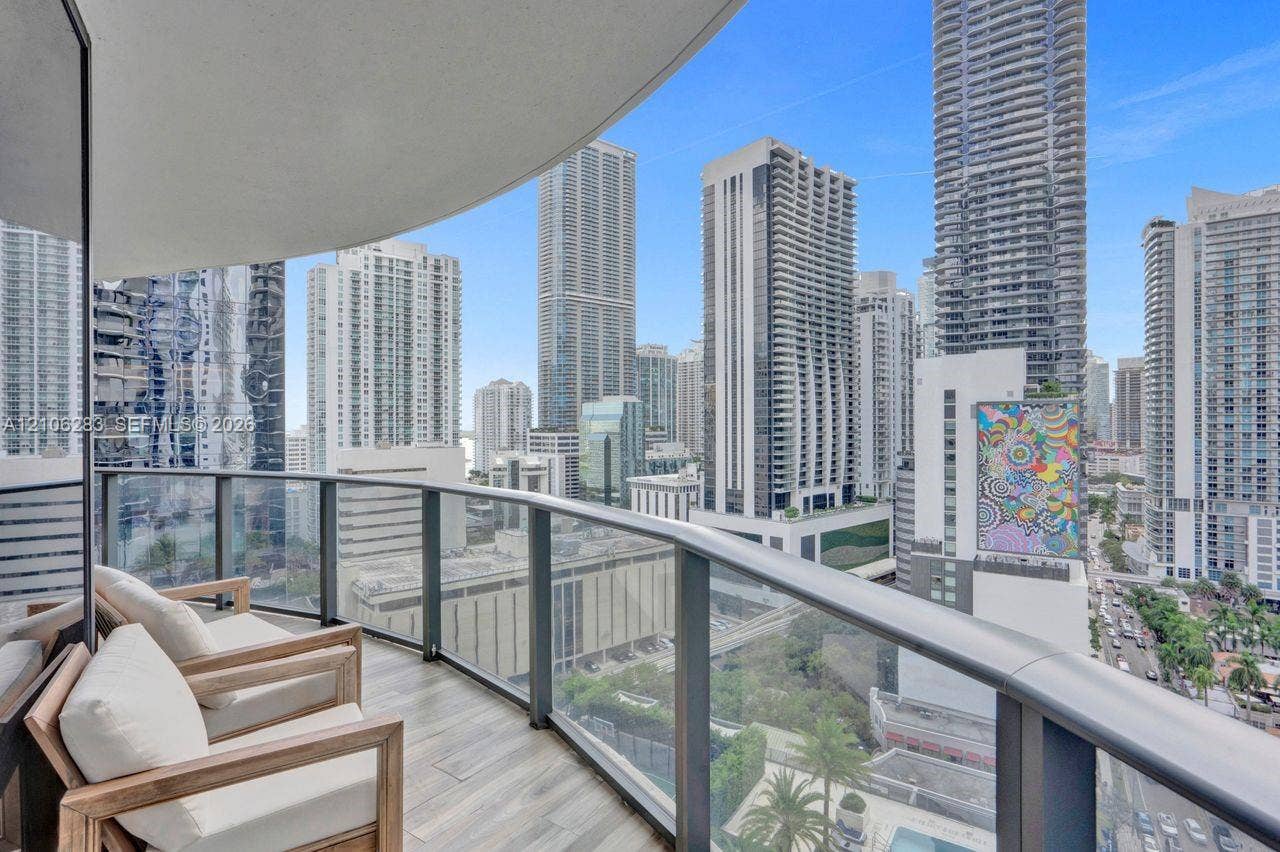 801 S Miami Avenue, #1801, Miami, FL 33130 Private balcony with tile flooring and a glass-paneled railing overlooking an urban cityscape