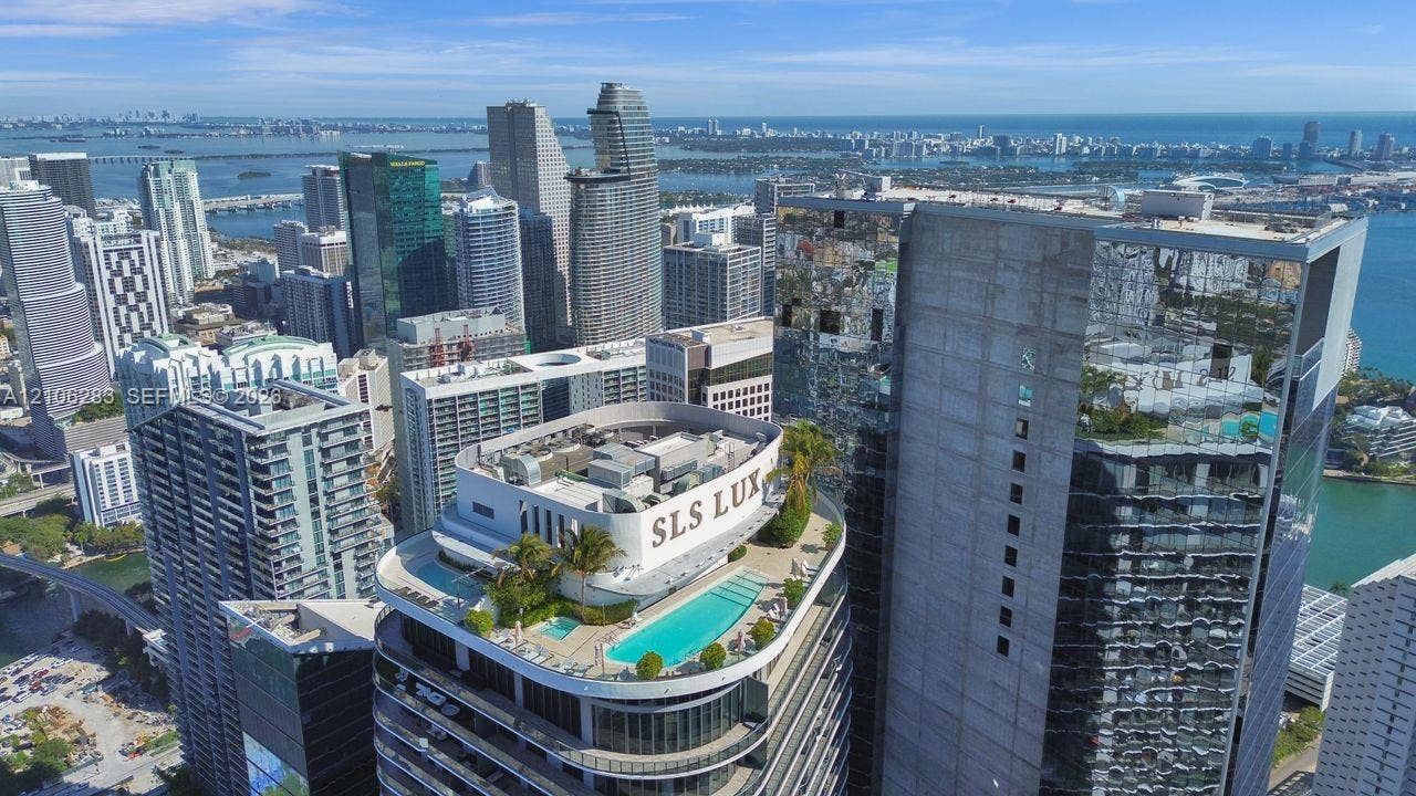 801 S Miami Avenue, #1801, Miami, FL 33130 Rooftop swimming pool and spa featuring a concrete terrace, perimeter landscaping, and glass balcony railings