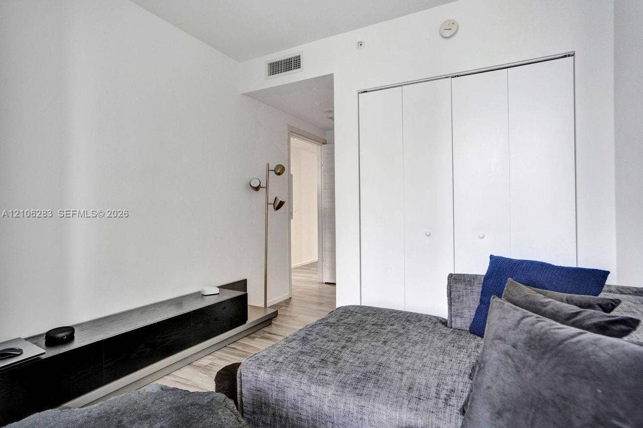 801 S Miami Avenue, #1801, Miami, FL 33130 Built-in wall-mounted shelving, wood-finish flooring, and dual-panel closet with matte hardware