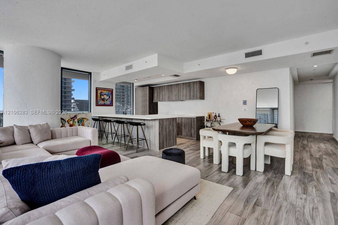 801 S Miami Avenue, #1801, Miami, FL 33130 Open-concept interior featuring wood-finish flooring, a kitchen island with stone countertop, and custom-finish cabinetry