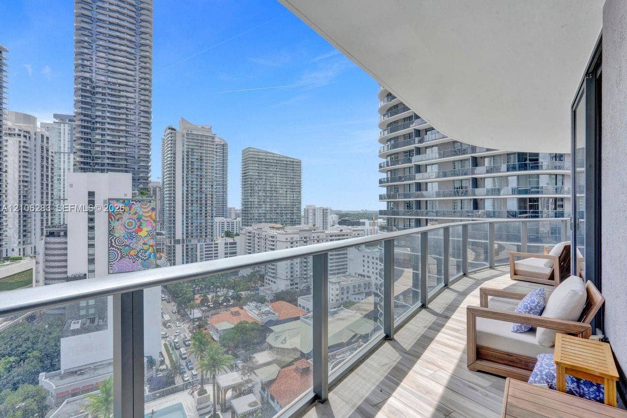 801 S Miami Avenue, #1801, Miami, FL 33130 Covered balcony featuring wood-finish flooring, glass-panel railing, and a metal handrail