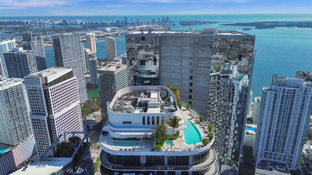 801 S Miami Avenue, #1801, Miami, FL 33130 Rooftop terrace featuring multiple swimming pools, integrated landscaping, and panoramic water and city skyline surroundings