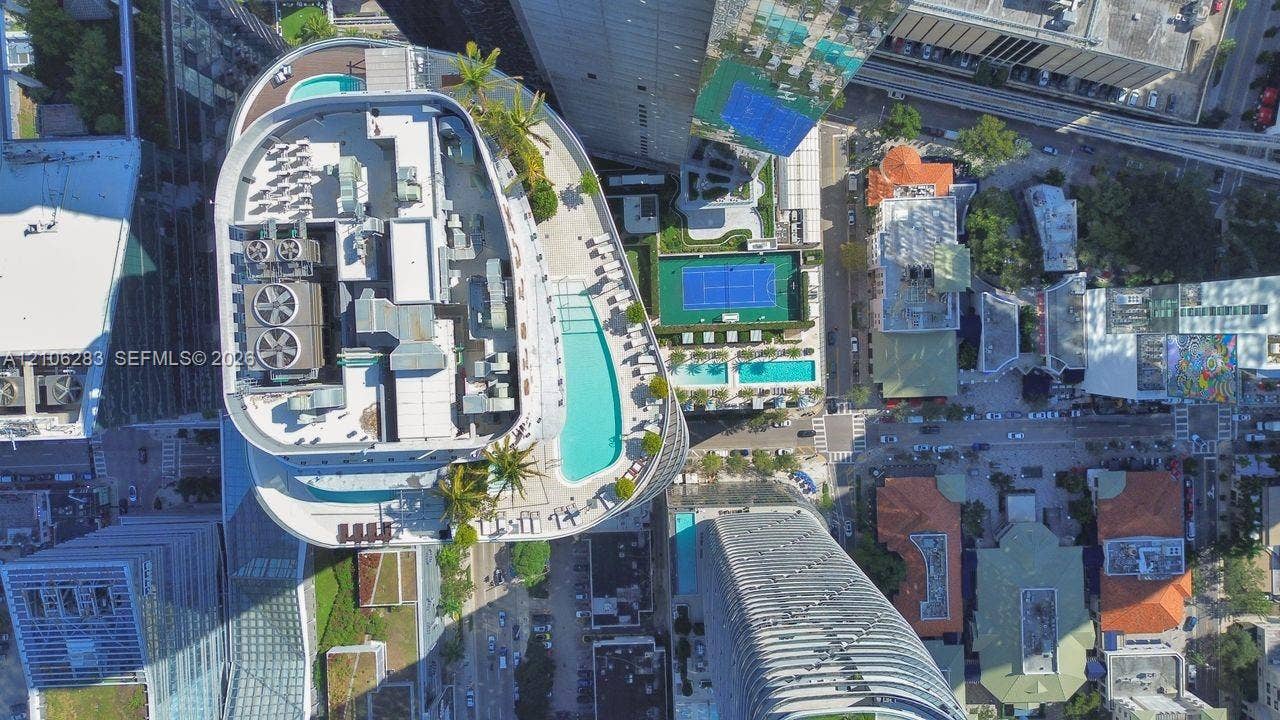 801 S Miami Avenue, #1801, Miami, FL 33130 Aerial perspective of building amenities featuring a rooftop swimming pool, landscaped terrace with palm trees, and hardscaped deck areas