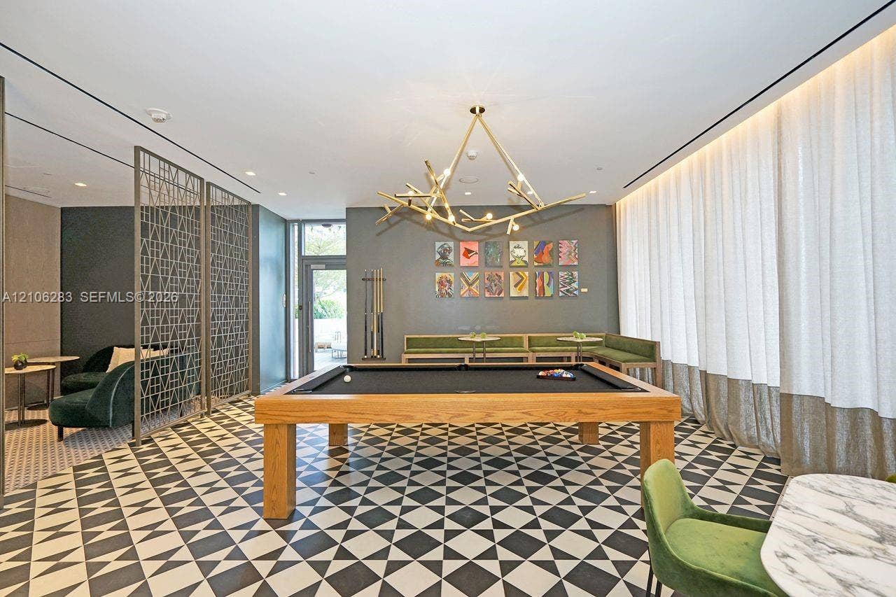 801 S Miami Avenue, #1801, Miami, FL 33130 Geometric patterned tile flooring, decorative metal room divider, branching sculptural pendant light, recessed ceiling lighting, and floor-to-ceiling drapery