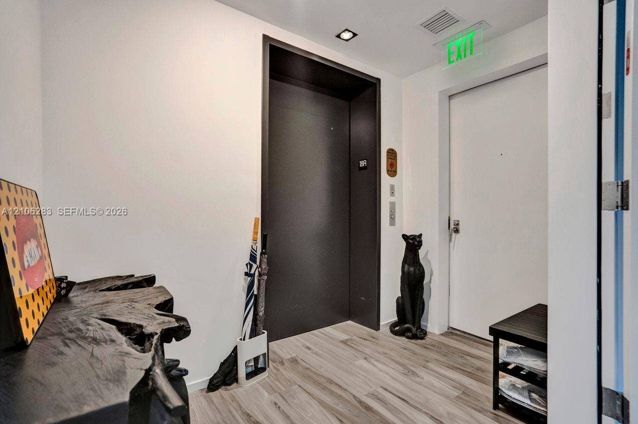 801 S Miami Avenue, #1801, Miami, FL 33130 Elevator landing featuring wood-finish flooring, recessed ceiling lighting, and a dark-finished elevator entry
