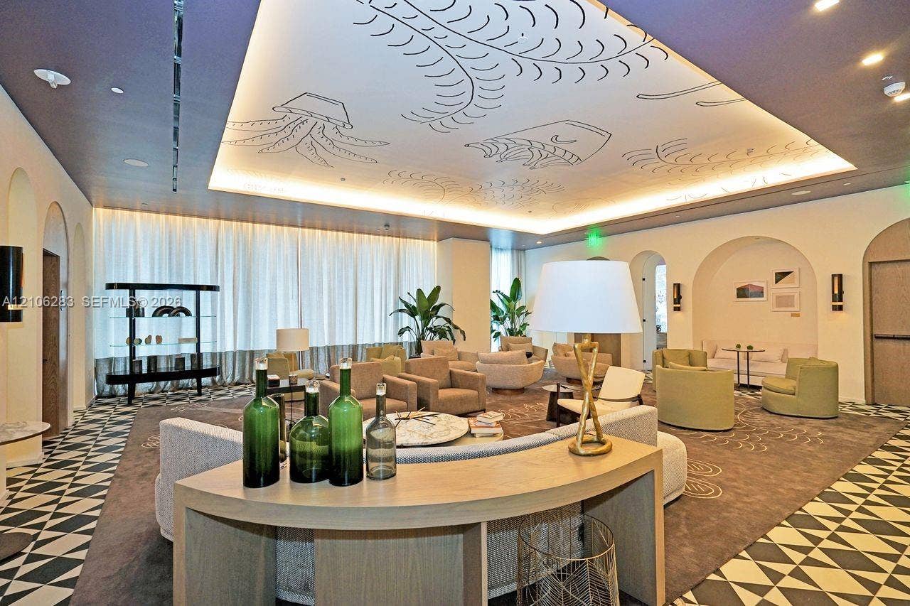 801 S Miami Avenue, #1801, Miami, FL 33130 Tray ceiling featuring custom illustrative detailing, recessed lighting, arched wall alcoves, and decorative geometric-patterned flooring
