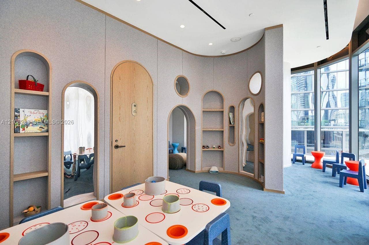801 S Miami Avenue, #1801, Miami, FL 33130 Curved wall paneling featuring integrated arched shelving, wood-finish arched doorways, floor-to-ceiling windows, and recessed ceiling lighting