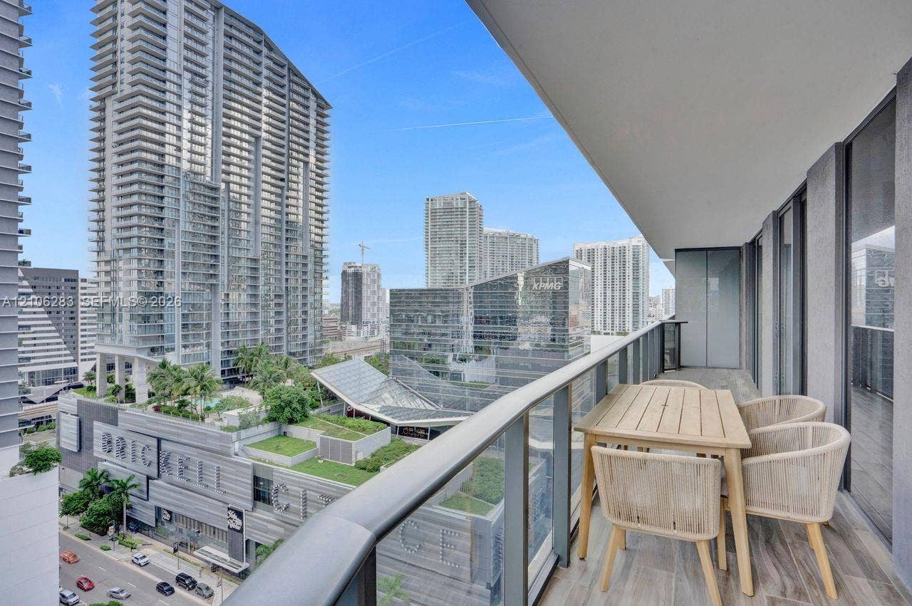 801 S Miami Avenue, #1801, Miami, FL 33130 Covered balcony featuring wood-finish flooring and a glass railing