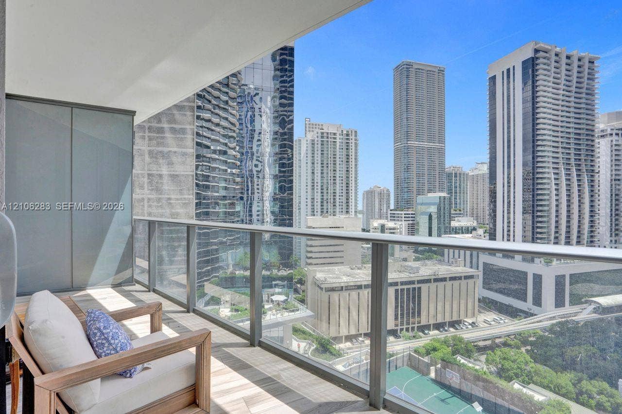 801 S Miami Avenue, #1801, Miami, FL 33130 Covered private balcony featuring tile flooring and a glass panel railing with a panoramic cityscape backdrop