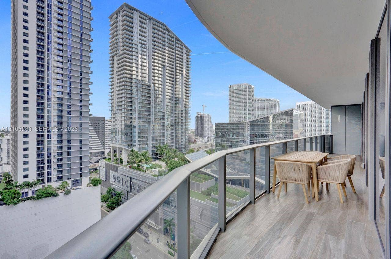 801 S Miami Avenue, #1801, Miami, FL 33130 Covered balcony featuring wood-finish flooring and a glass-paneled metal railing