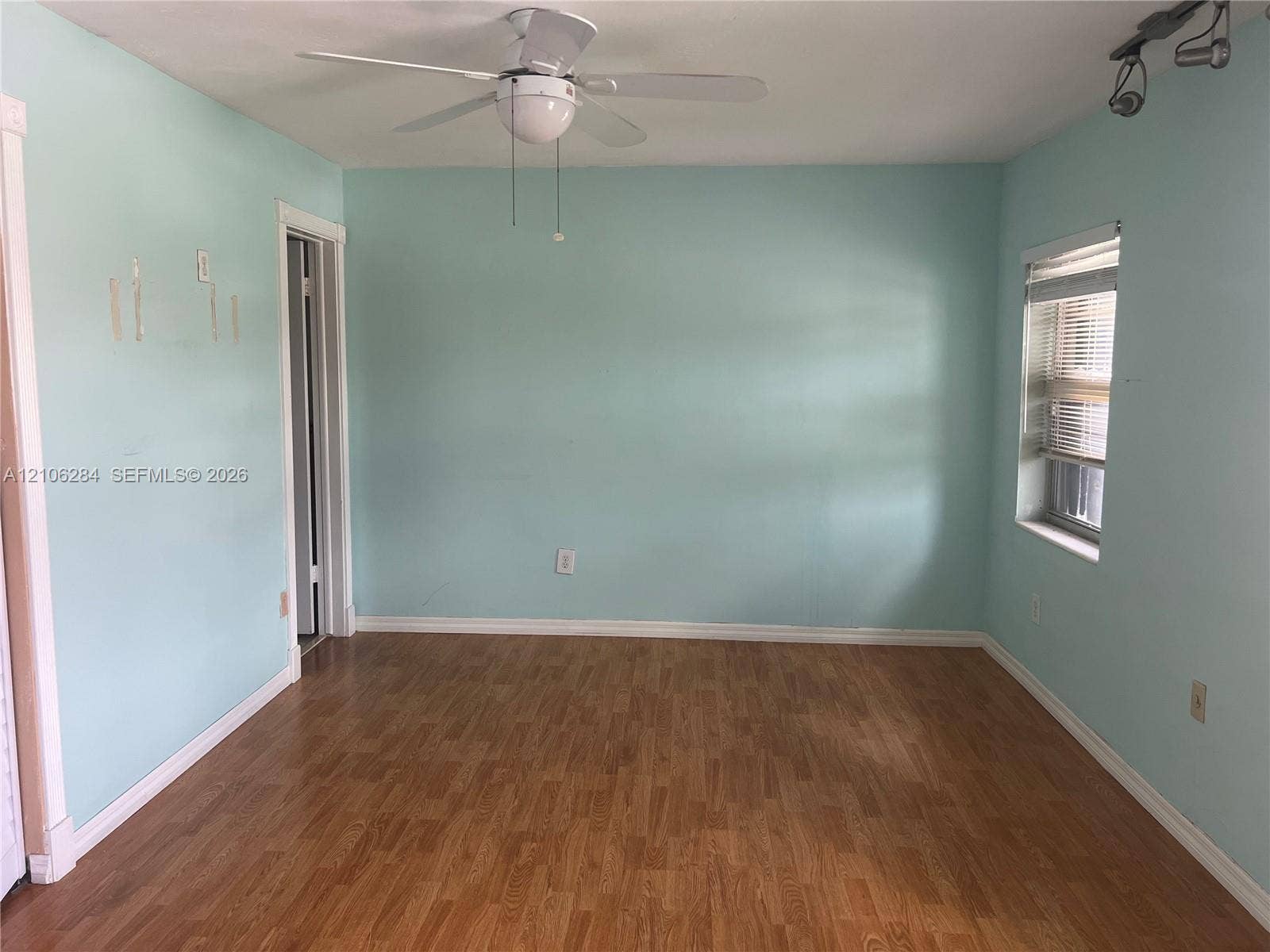 11824 SW 123rd Avenue, #., Miami, Miami, FL 33186 Interior room featuring wood-finish flooring, a ceiling fan with integrated light fixture, and adjustable track lighting