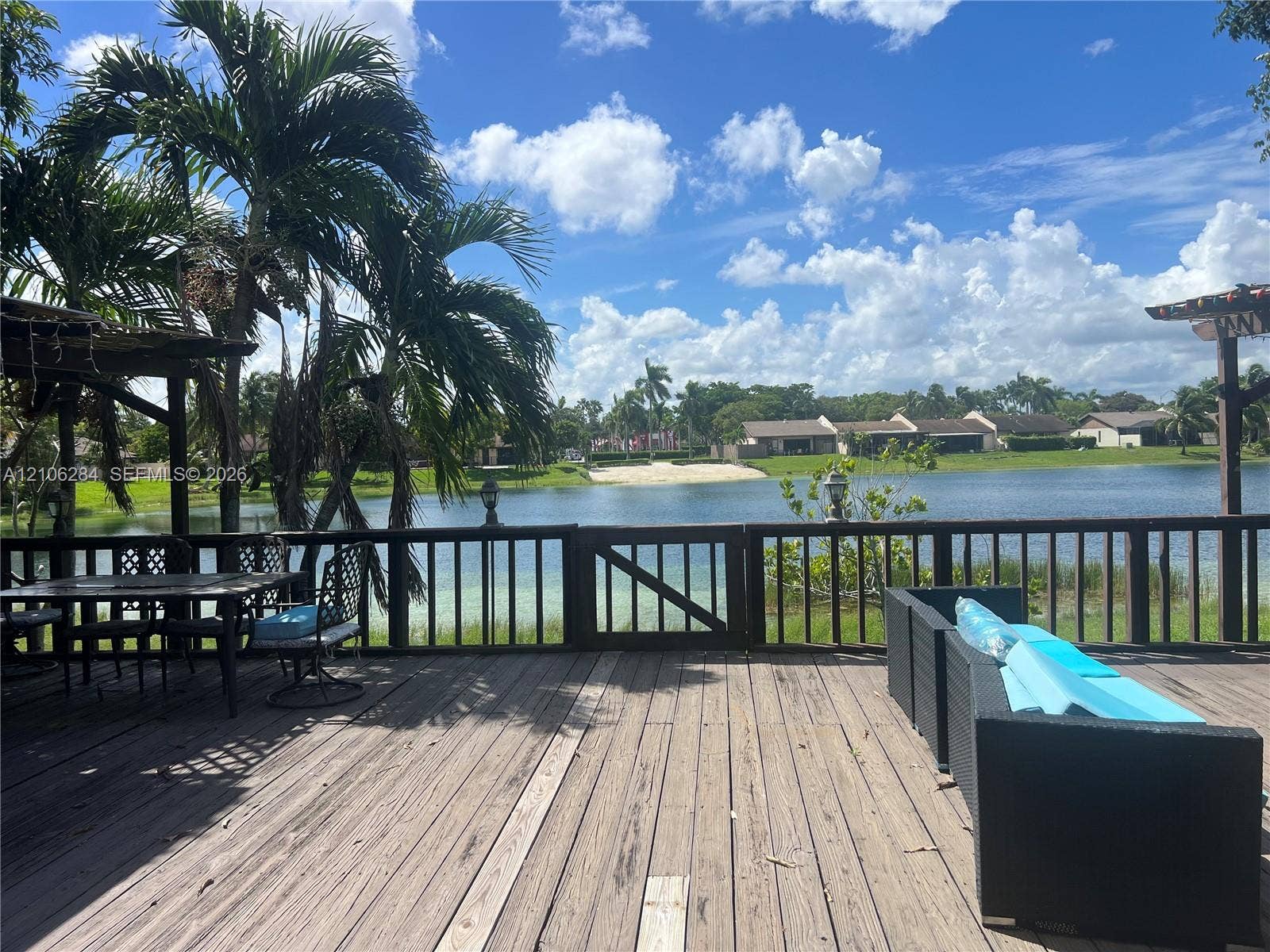 11824 SW 123rd Avenue, #., Miami, Miami, FL 33186 Expansive wooden deck featuring perimeter railing, overhead pergola structures, and direct water frontage