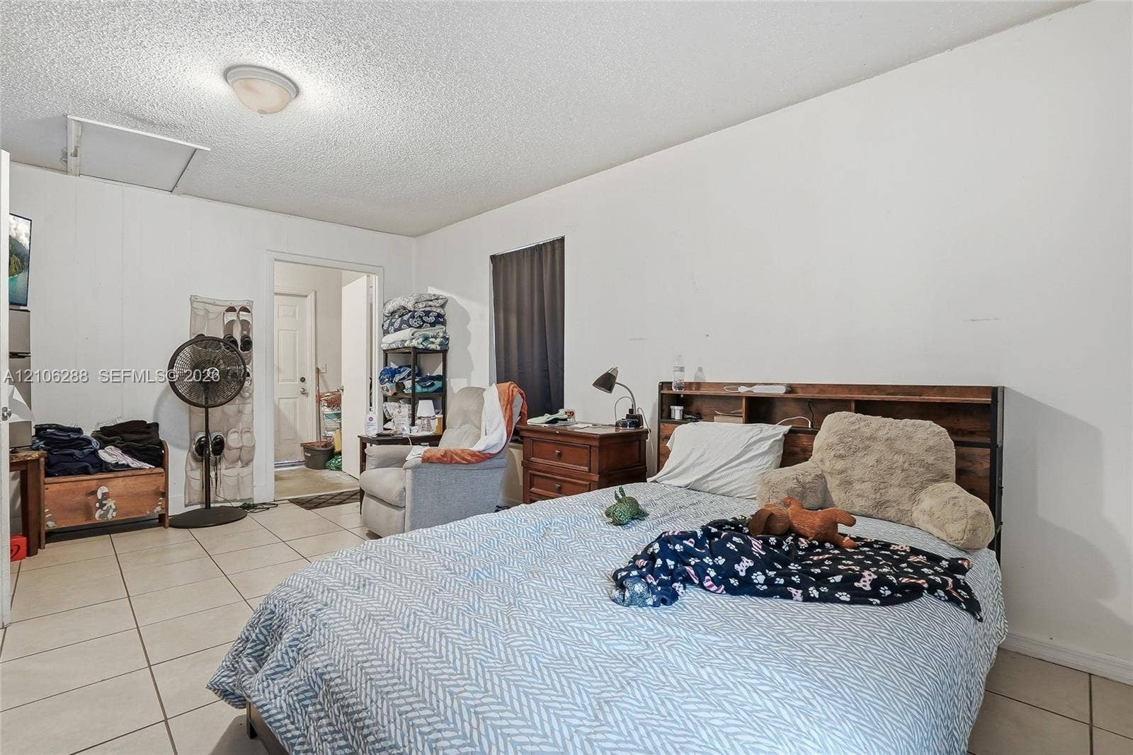 Ceramic tile flooring, white walls, and a ceiling-mounted light fixture