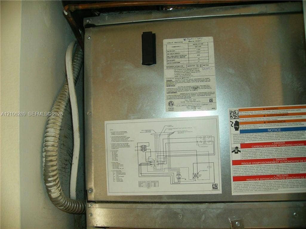 Metal HVAC air handler unit featuring a detailed technical schematic, manufacturer specifications, and safety signage