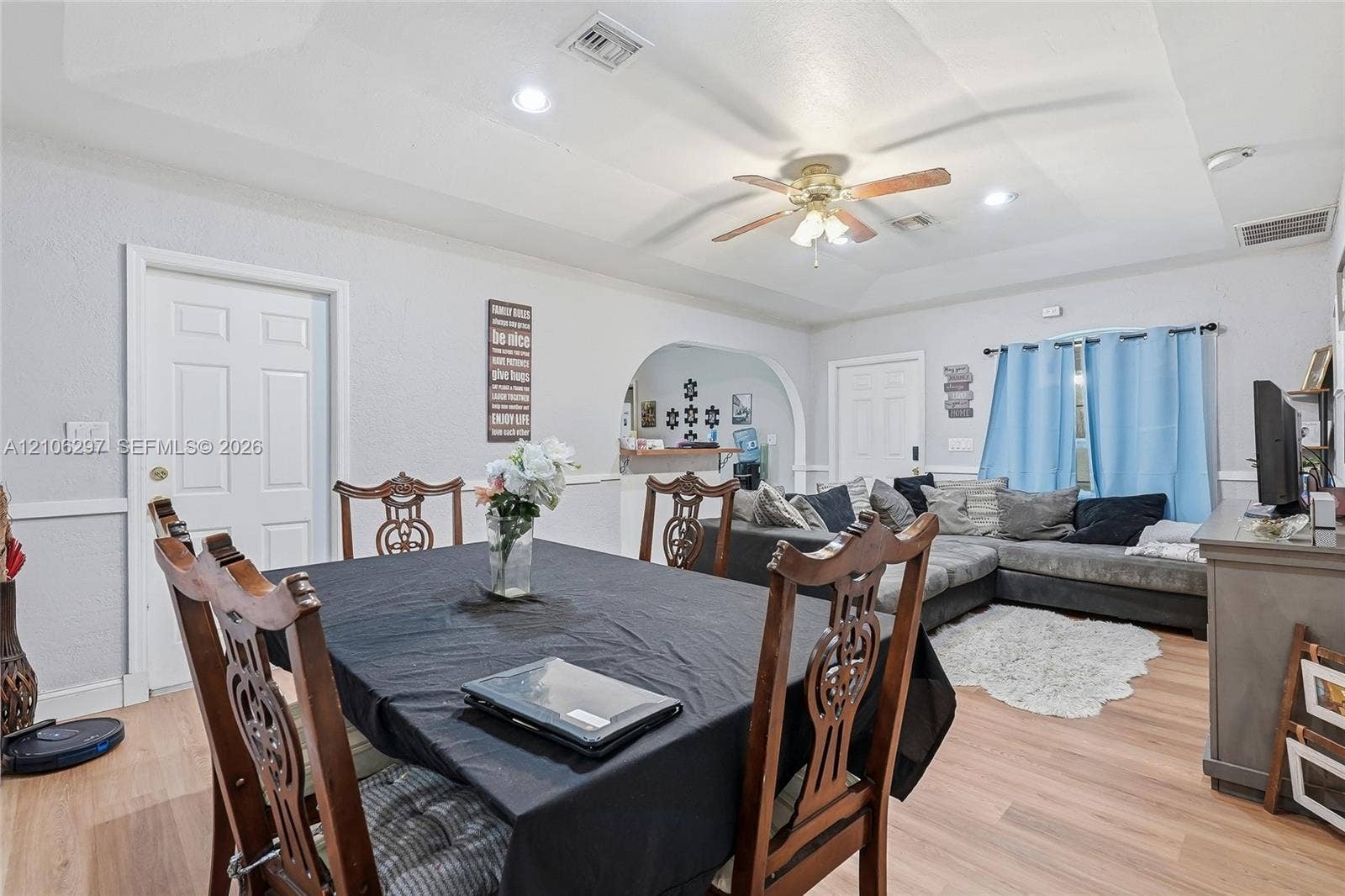 4810 Lakewood Park Drive, Fort Pierce, FL 34951 Tray ceiling with recessed lighting, central ceiling fan, arched wall opening, and wood-finish flooring