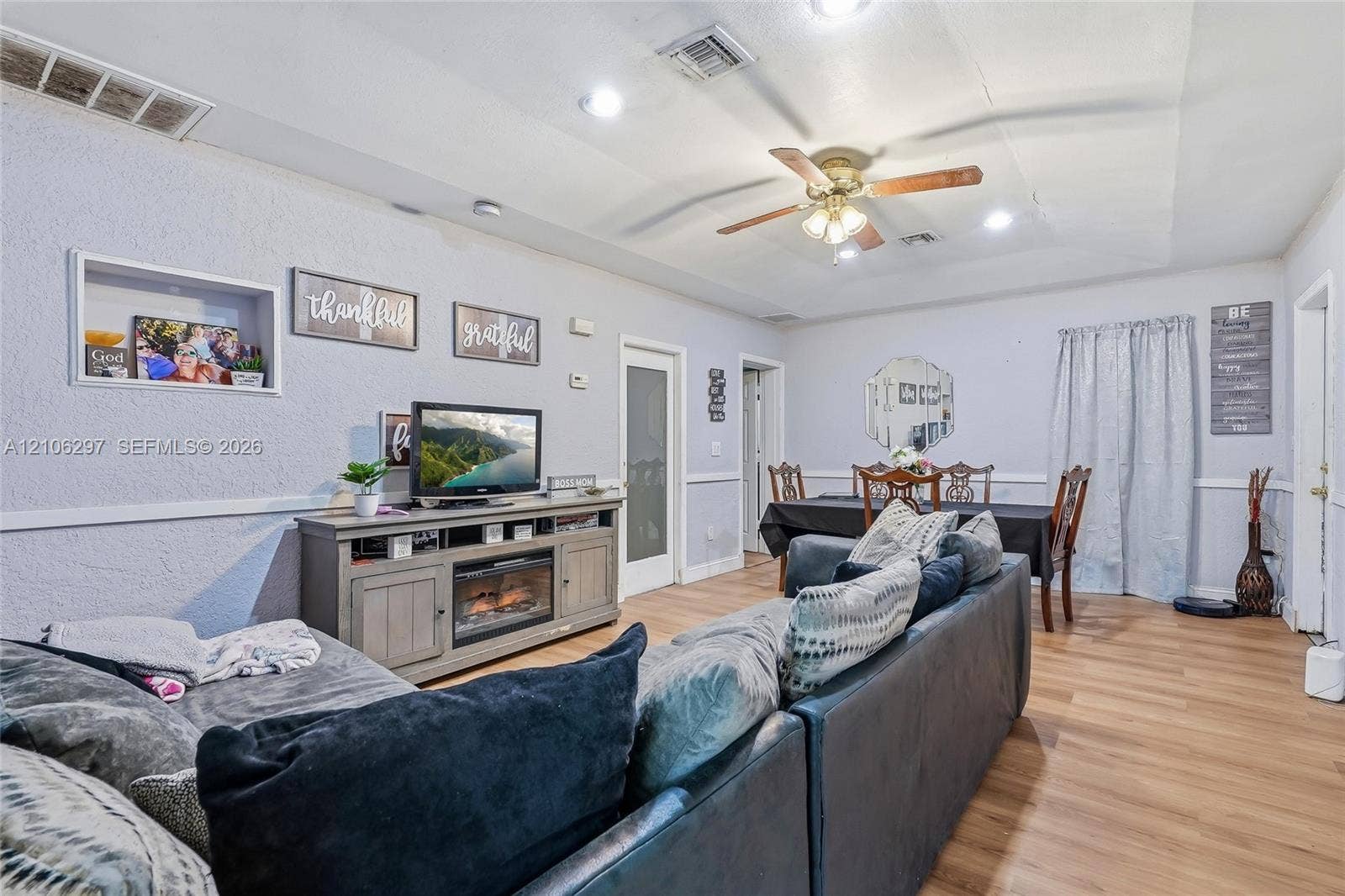 4810 Lakewood Park Drive, Fort Pierce, FL 34951 Tray ceiling featuring recessed lighting and a ceiling fan, wood-finish flooring, and a built-in recessed wall niche