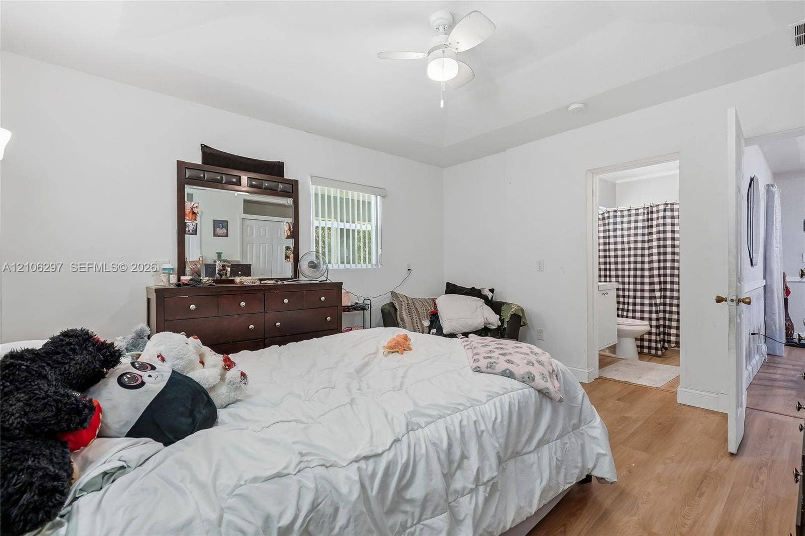 4810 Lakewood Park Drive, Fort Pierce, FL 34951 Tray ceiling, white-finish ceiling fan with integrated lighting, wood-finish flooring, and multi-pane window