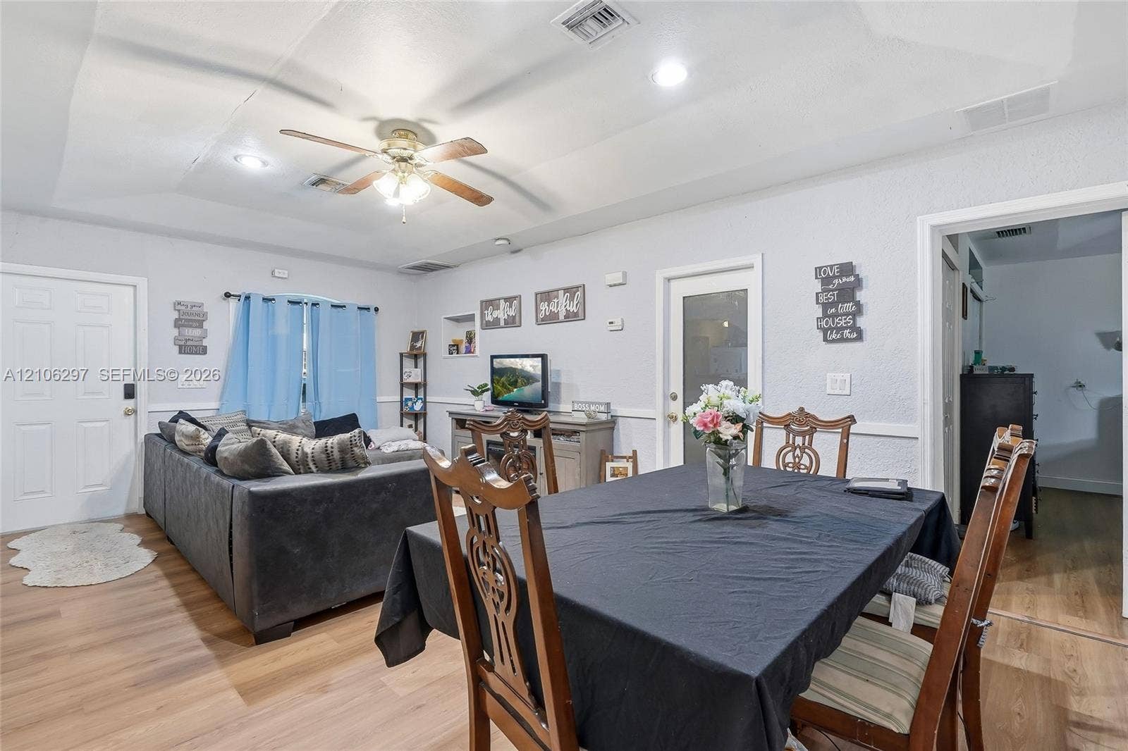 4810 Lakewood Park Drive, Fort Pierce, FL 34951 Tray ceiling featuring recessed lighting and a central ceiling fan, complemented by wood-finish flooring and chair rail molding