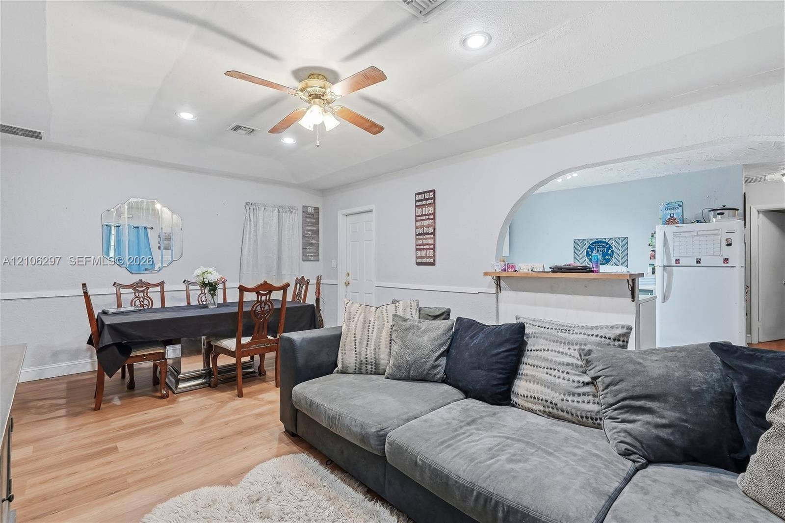 4810 Lakewood Park Drive, Fort Pierce, FL 34951 Living area featuring wood-finish flooring, recessed lighting, ceiling fan with light kit, arched wall opening, and chair rail molding