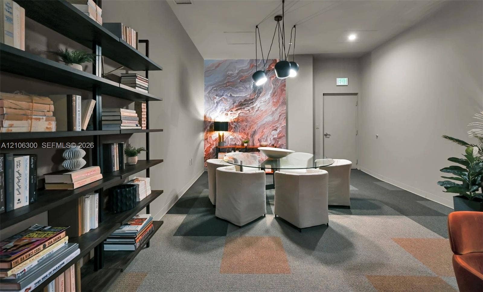 480 NE 31st Street, #1005, Miami, Miami, FL 33137 Floor-to-ceiling built-in black metal shelving unit, geometric patterned modular carpeting, decorative marble-finish accent wall, and multi-pendant modern light fixture