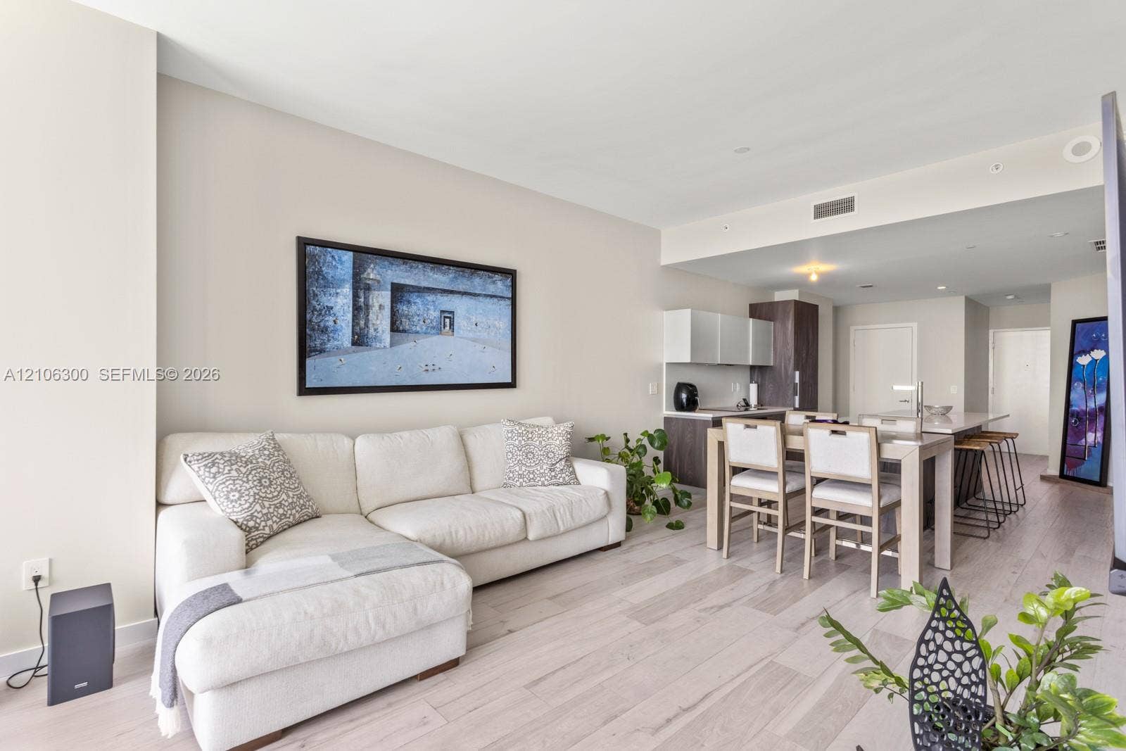 480 NE 31st Street, #1005, Miami, Miami, FL 33137 Open-concept living space featuring wood-finish flooring, recessed lighting, and a kitchen equipped with a central island and contemporary cabinetry