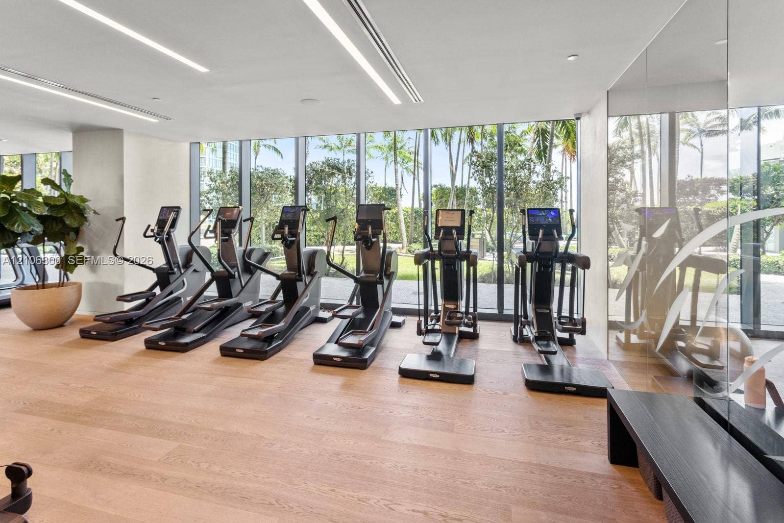 480 NE 31st Street, #1005, Miami, Miami, FL 33137 Fitness center featuring floor-to-ceiling windows, wood-finish flooring, mirrored wall, and recessed linear lighting