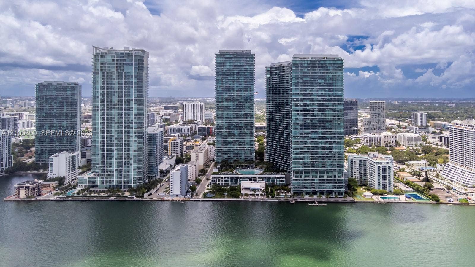 480 NE 31st Street, #1005, Miami, Miami, FL 33137 High-rise waterfront complex featuring glass-facade towers, a central swimming pool, and extensive manicured landscaping