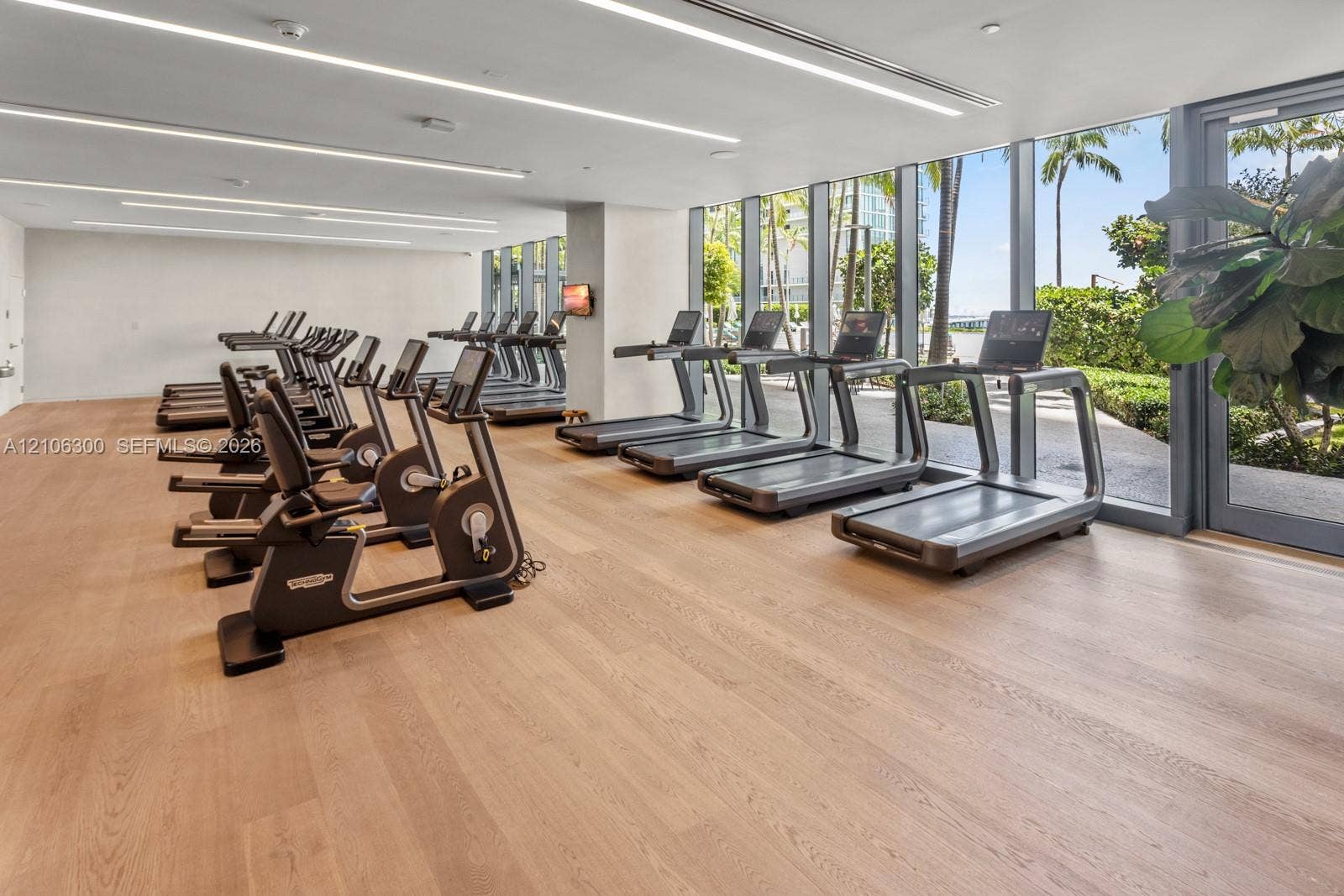 480 NE 31st Street, #1005, Miami, Miami, FL 33137 Fitness center featuring wood-finish flooring, floor-to-ceiling windows, and recessed linear lighting