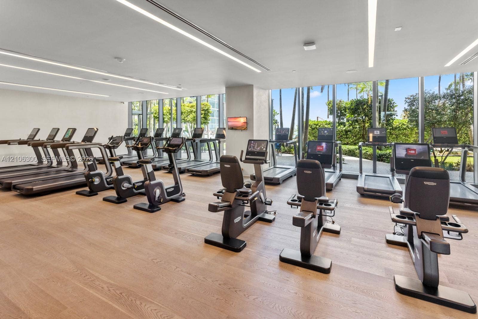 480 NE 31st Street, #1005, Miami, Miami, FL 33137 Fitness center featuring wood-finish flooring, floor-to-ceiling windows, and recessed linear lighting
