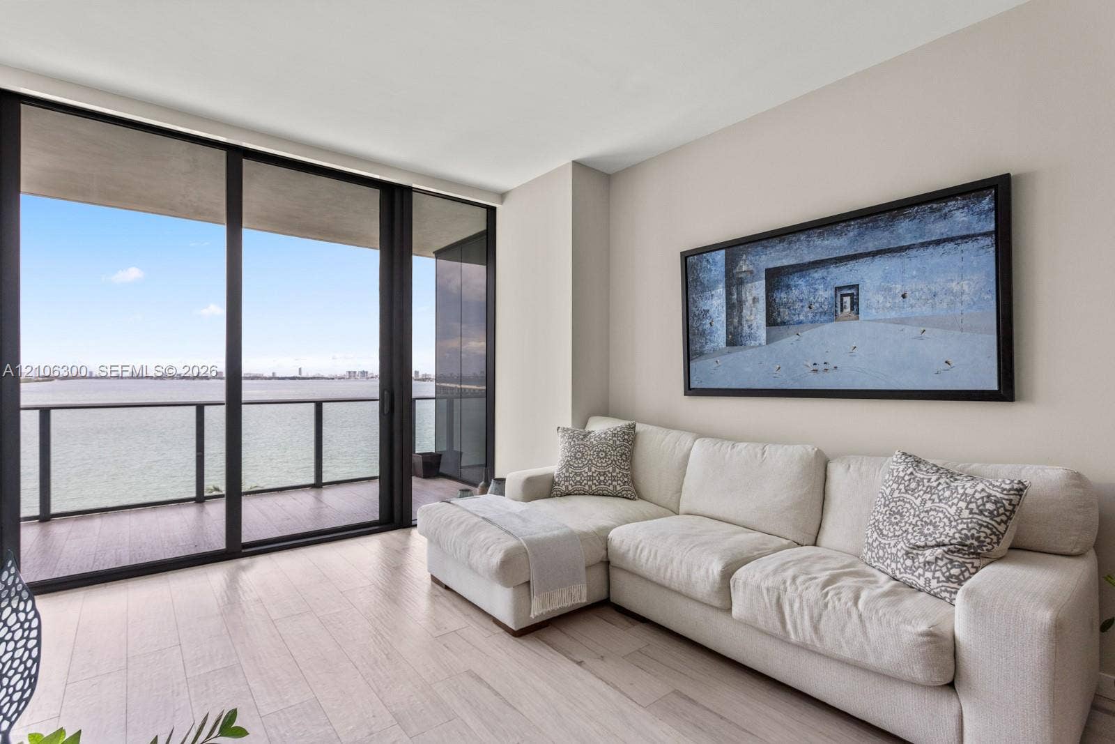 480 NE 31st Street, #1005, Miami, Miami, FL 33137 Floor-to-ceiling sliding glass doors, private balcony with metal railing, and wood-finish flooring