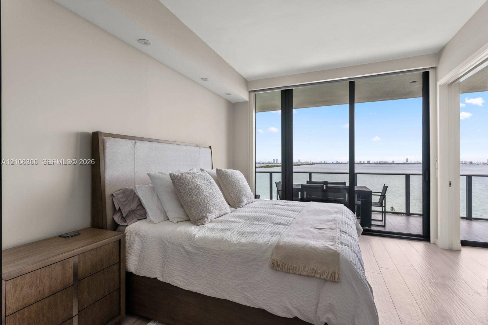 480 NE 31st Street, #1005, Miami, Miami, FL 33137 Floor-to-ceiling windows, wood-finish flooring, recessed lighting, and a private balcony with water backdrop