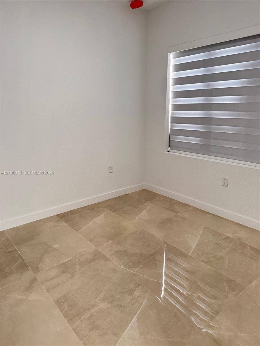 14508 SW 260th Street, #14508, Homestead, Homestead, FL 33032 Neutral-toned large-format tile flooring, white walls, and horizontal dual-layer window treatments