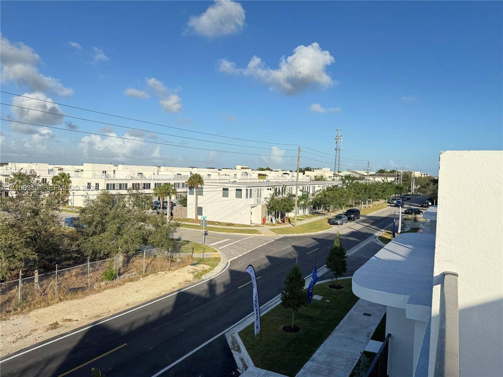 14508 SW 260th Street, #14508, Homestead, Homestead, FL 33032 Elevated exterior balcony with a metal railing overlooking paved local streets and manicured landscaping