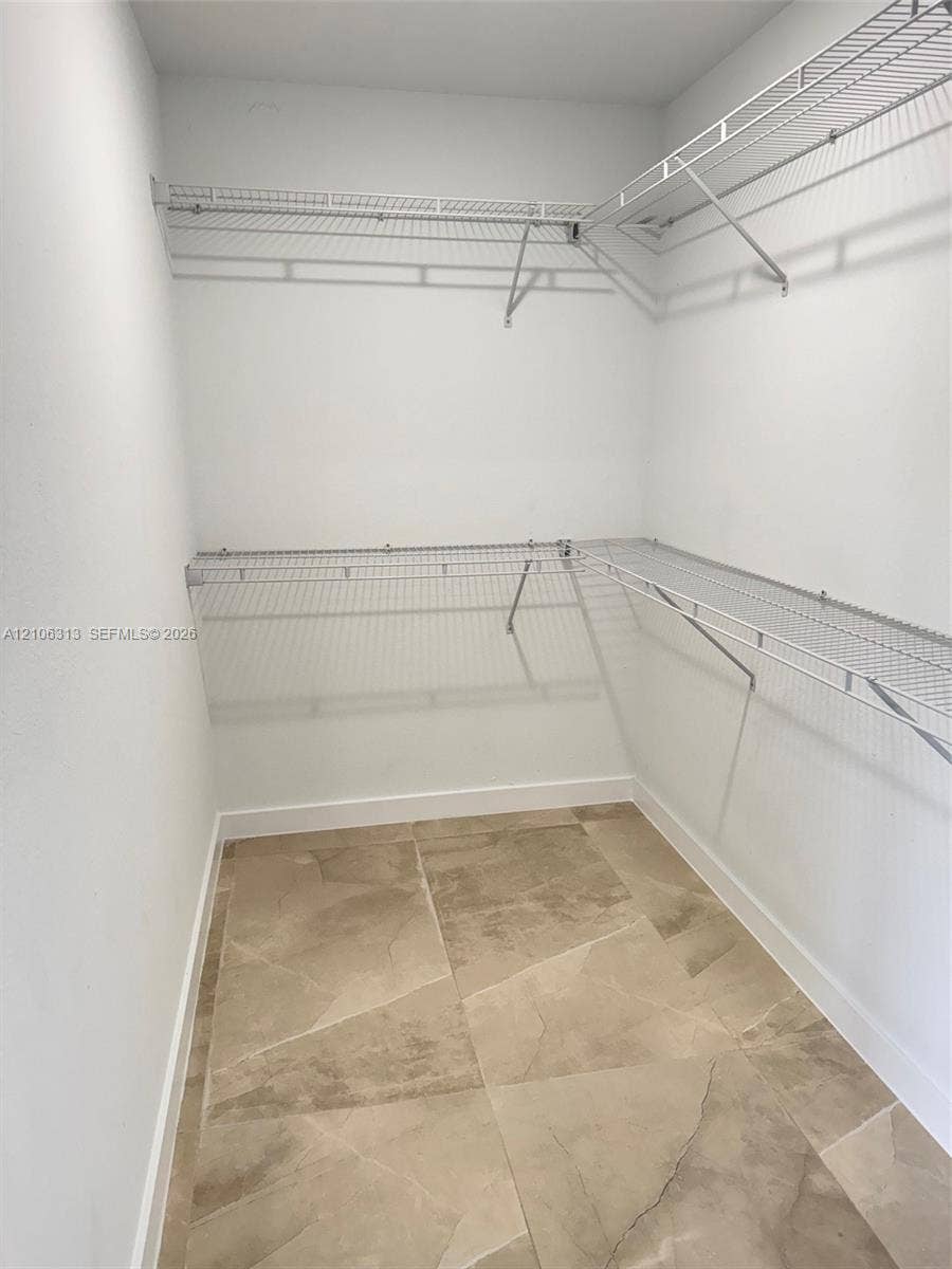 14508 SW 260th Street, #14508, Homestead, Homestead, FL 33032 Walk-in closet featuring large-format tile flooring and tiered wire shelving