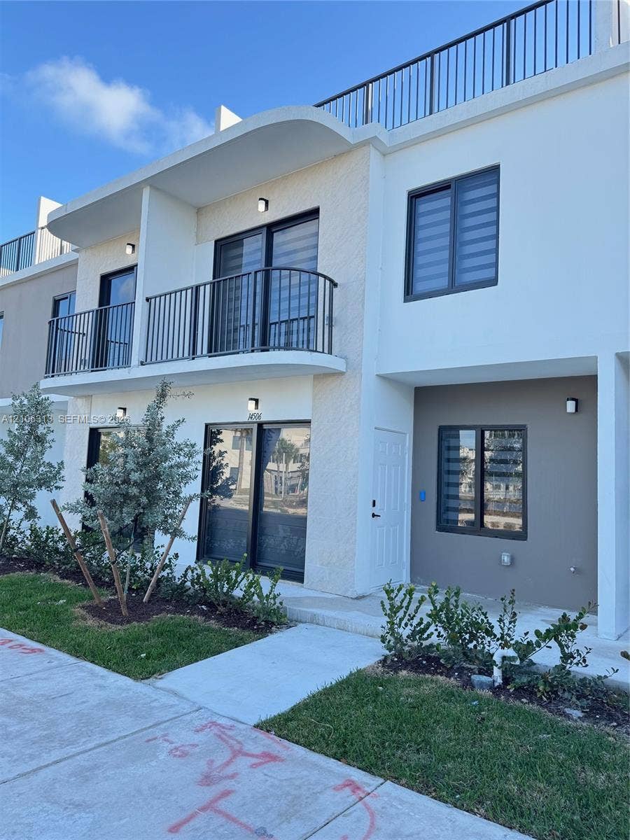 14508 SW 260th Street, #14508, Homestead, Homestead, FL 33032 Contemporary multi-story exterior featuring a private second-level balcony with metal railing, rooftop terrace, sliding glass doors, and integrated wall-mounted lighting