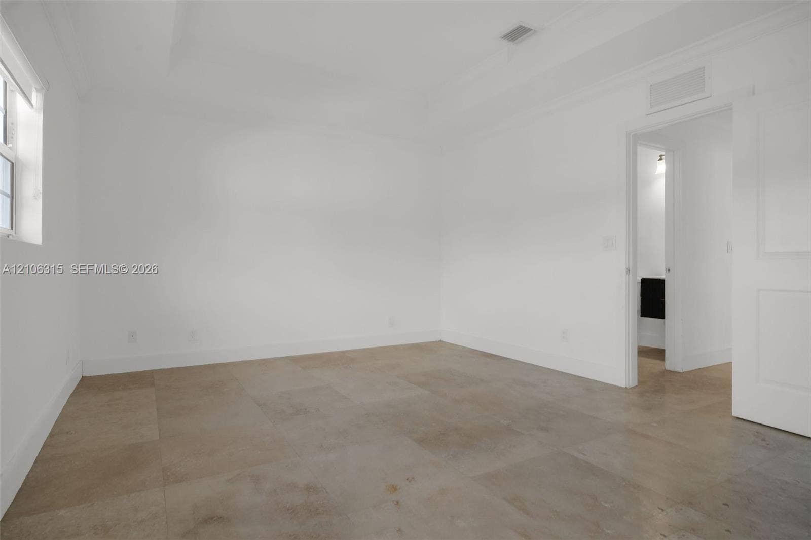 2319 NE 35th Drive, Fort Lauderdale, FL 33308 Neutral-toned tile flooring, recessed ceiling detailing, and crisp white wall finishes