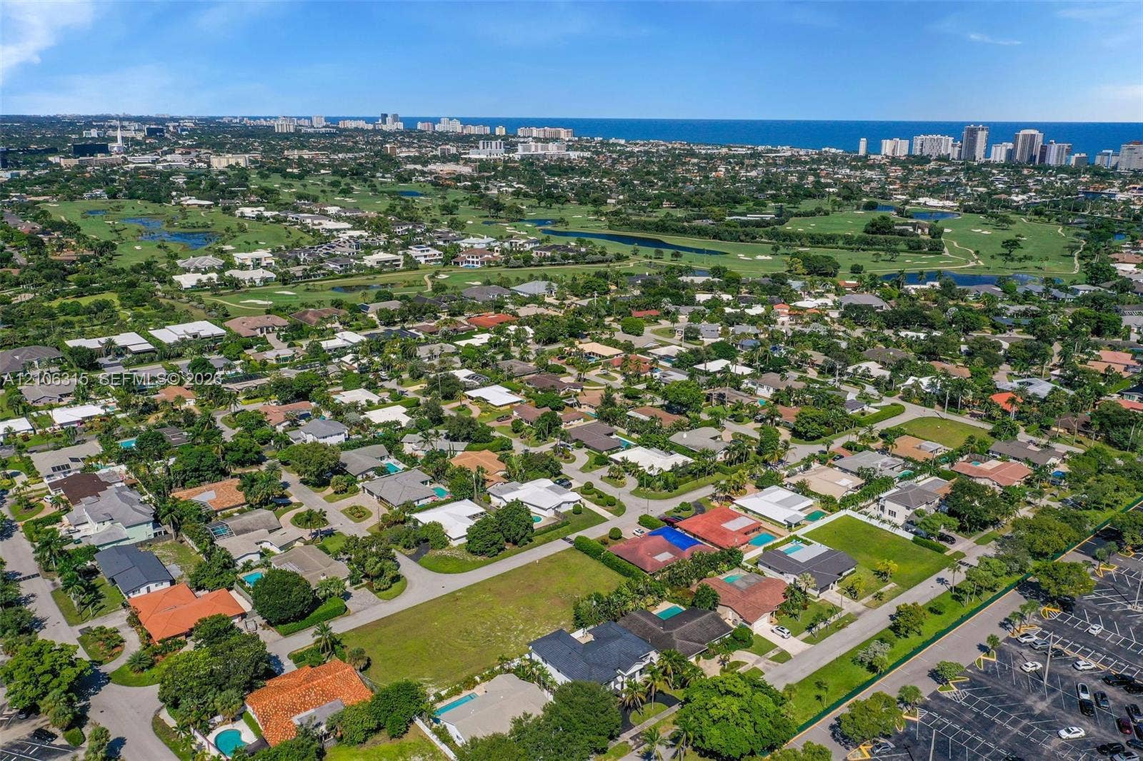 2319 NE 35th Drive, Fort Lauderdale, FL 33308 Aerial perspective of a residential neighborhood featuring expansive green space, mature landscaping, and proximity to the coastline