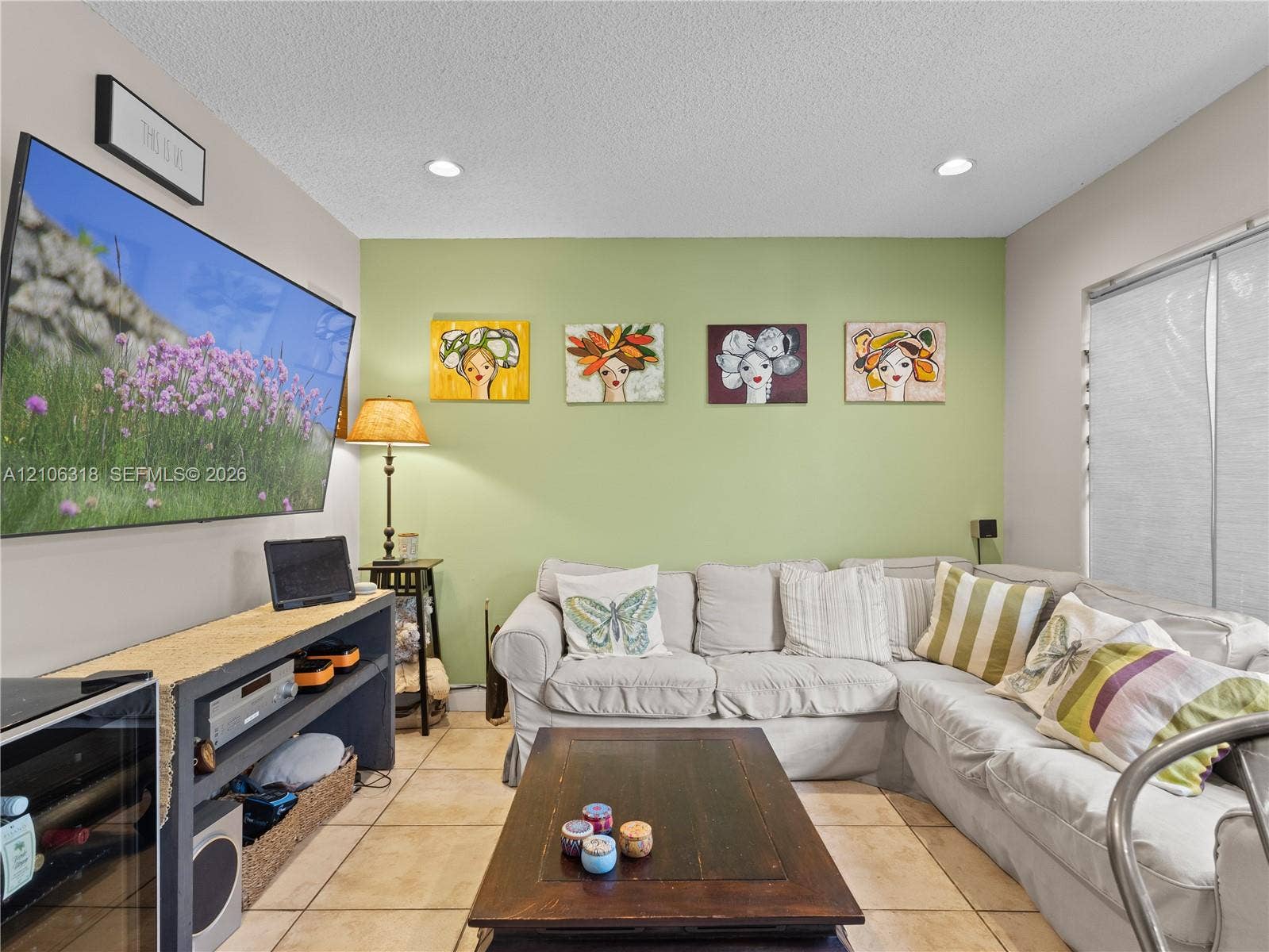 9921 NW 51st Lane, Doral, FL 33178 Living area featuring neutral-toned tile flooring, recessed lighting, and a green accent wall