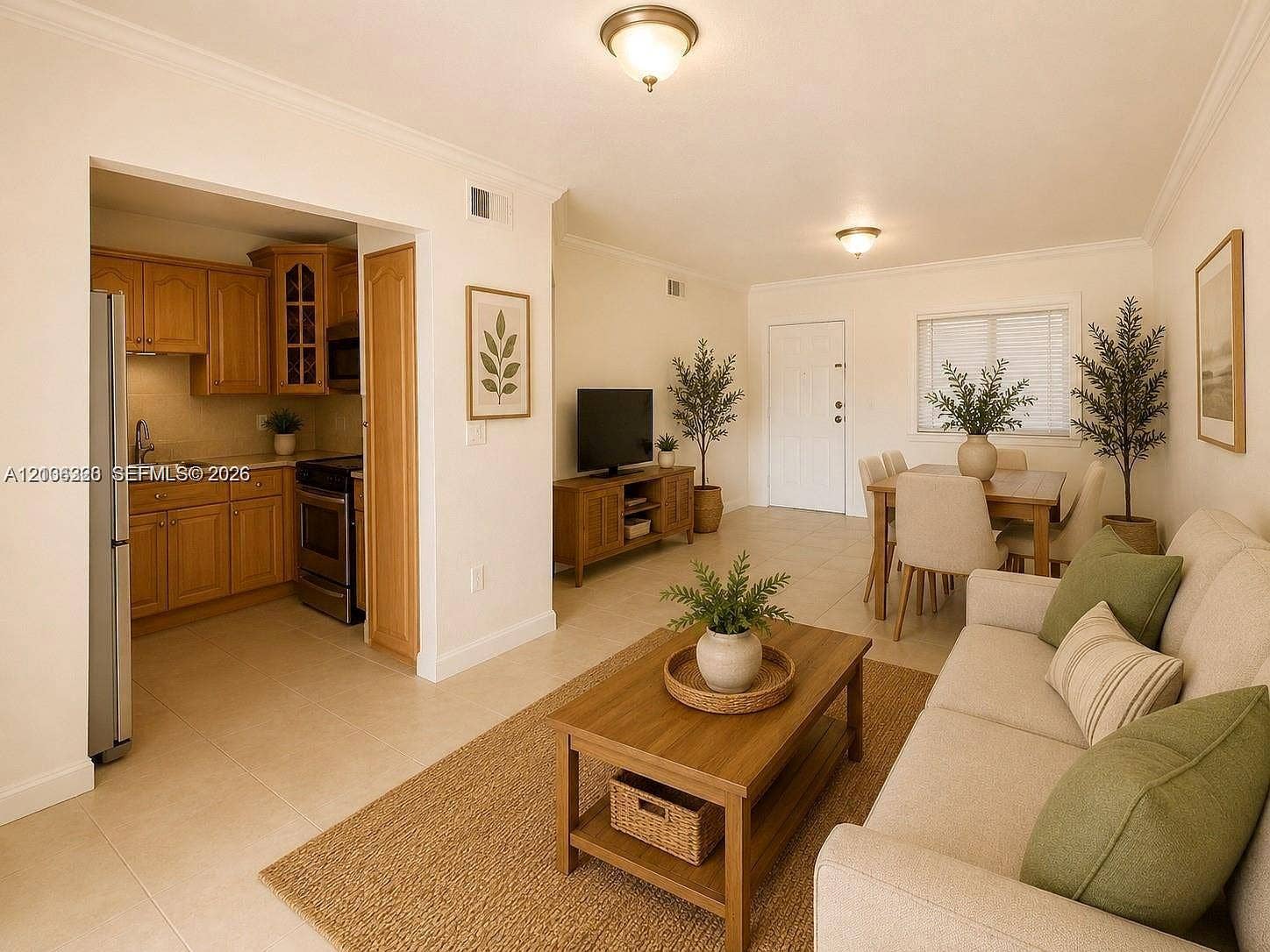 Open-concept layout featuring neutral ceramic tile flooring, crown molding, and wooden cabinetry with glass-front detailing