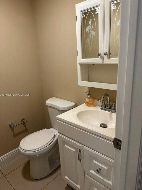 220 NW 87th Avenue, #K212, Miami, Miami, FL 33172 White vanity cabinet with an integrated basin, chrome-finish dual-handle faucet, and wall-mounted upper cabinet featuring etched glass door panels