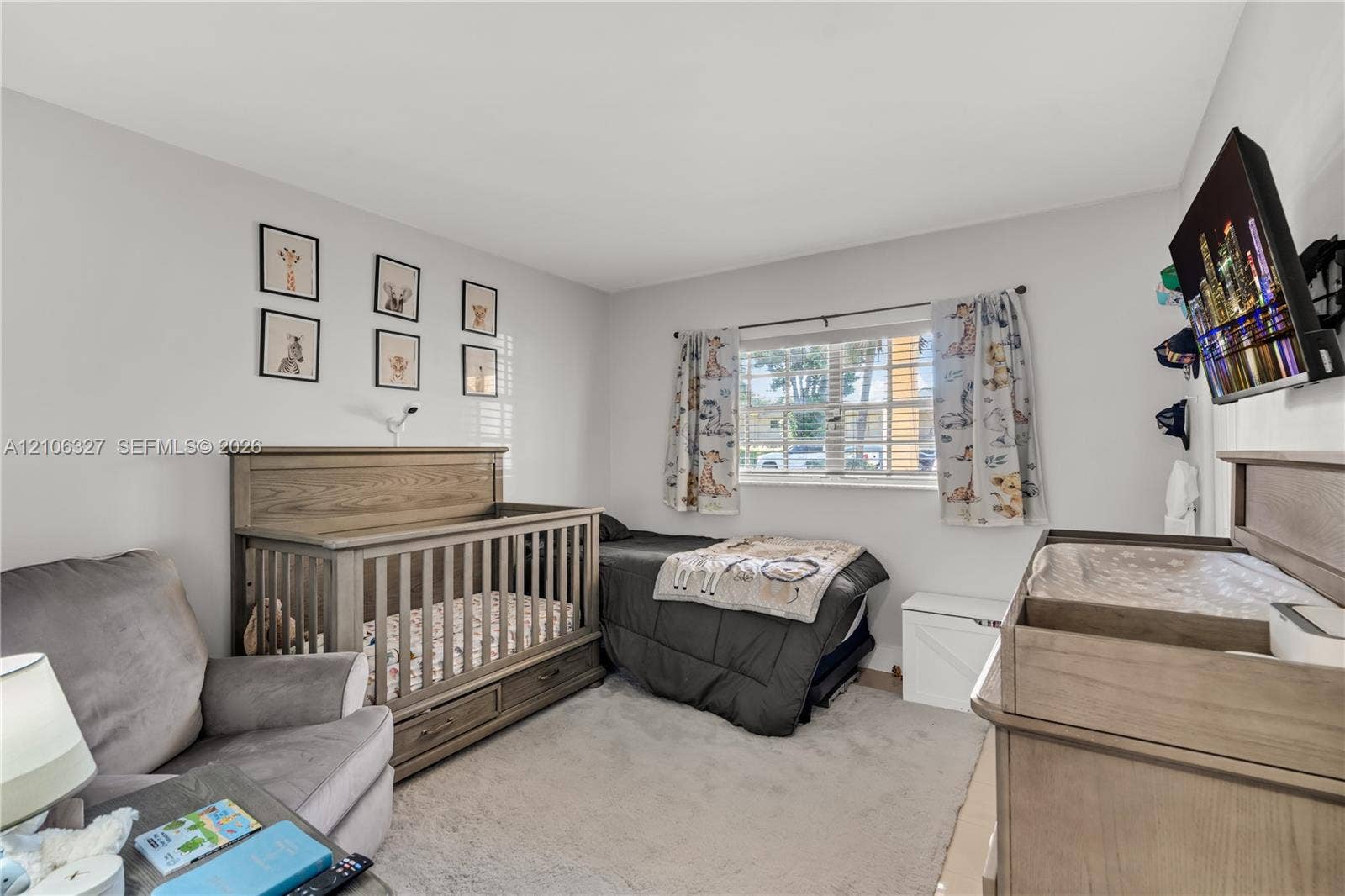 Bedroom featuring neutral wall paint, plush carpeting, and a window with horizontal blinds