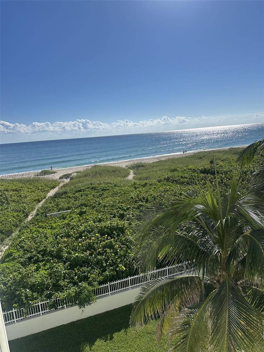 3600 N Ocean Drive, #423, Riviera Beach, Riviera Beach, FL 33404 Oceanfront scenery featuring a sandy coastline, native dune vegetation, and a white perimeter fence