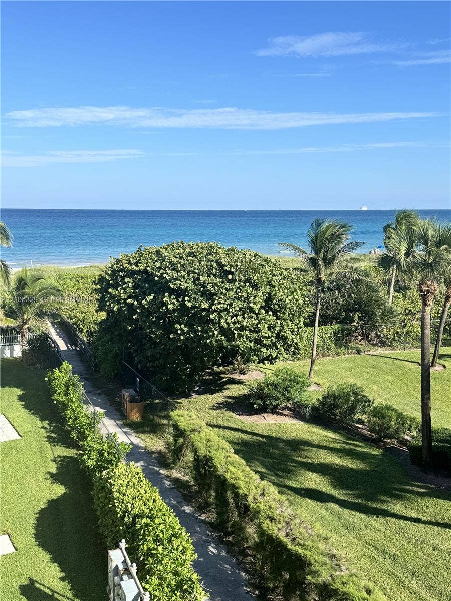 3600 N Ocean Drive, #423, Riviera Beach, Riviera Beach, FL 33404 Oceanfront scenery featuring a paved walkway, manicured lawn, native coastal vegetation, and palm trees