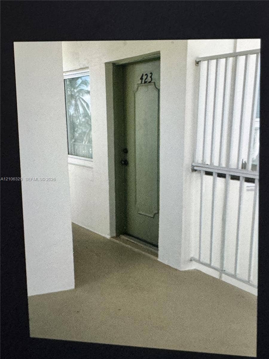 3600 N Ocean Drive, #423, Riviera Beach, Riviera Beach, FL 33404 Entryway featuring a solid-panel door with recessed detailing, a metal-framed window, and a metal safety railing