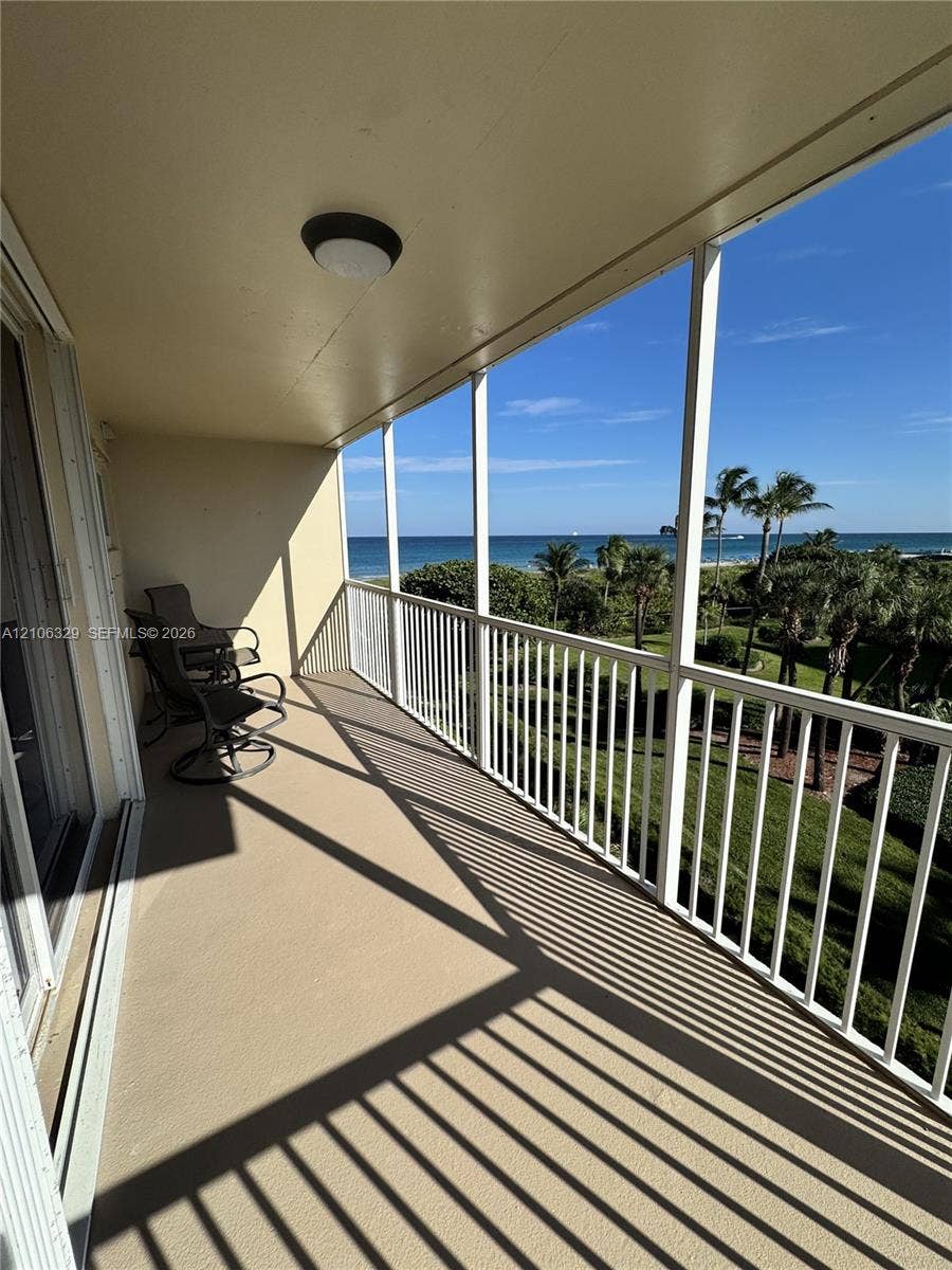 3600 N Ocean Drive, #423, Riviera Beach, Riviera Beach, FL 33404 Covered balcony with white metal railings, concrete flooring, and ceiling-mounted light fixture