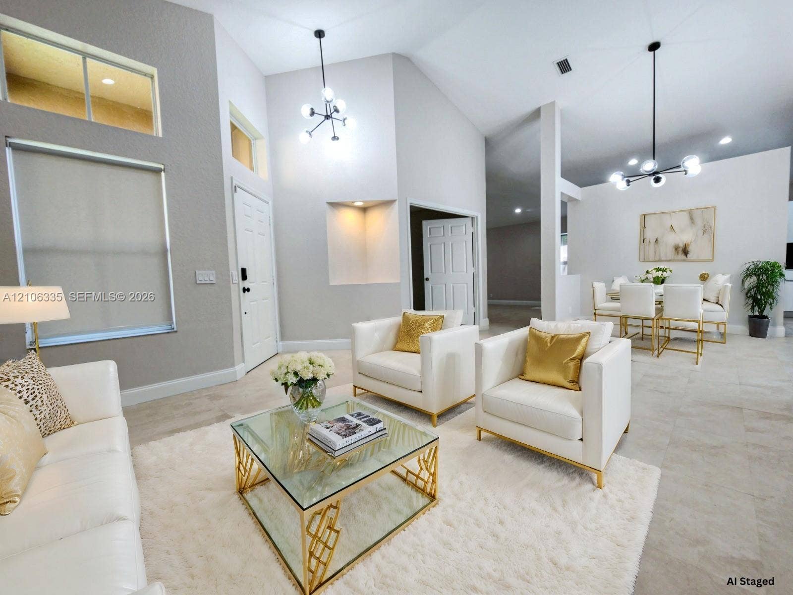 Vaulted ceilings featuring multi-arm modern chandeliers, oversized windows with transom accents, and large-format neutral tile flooring