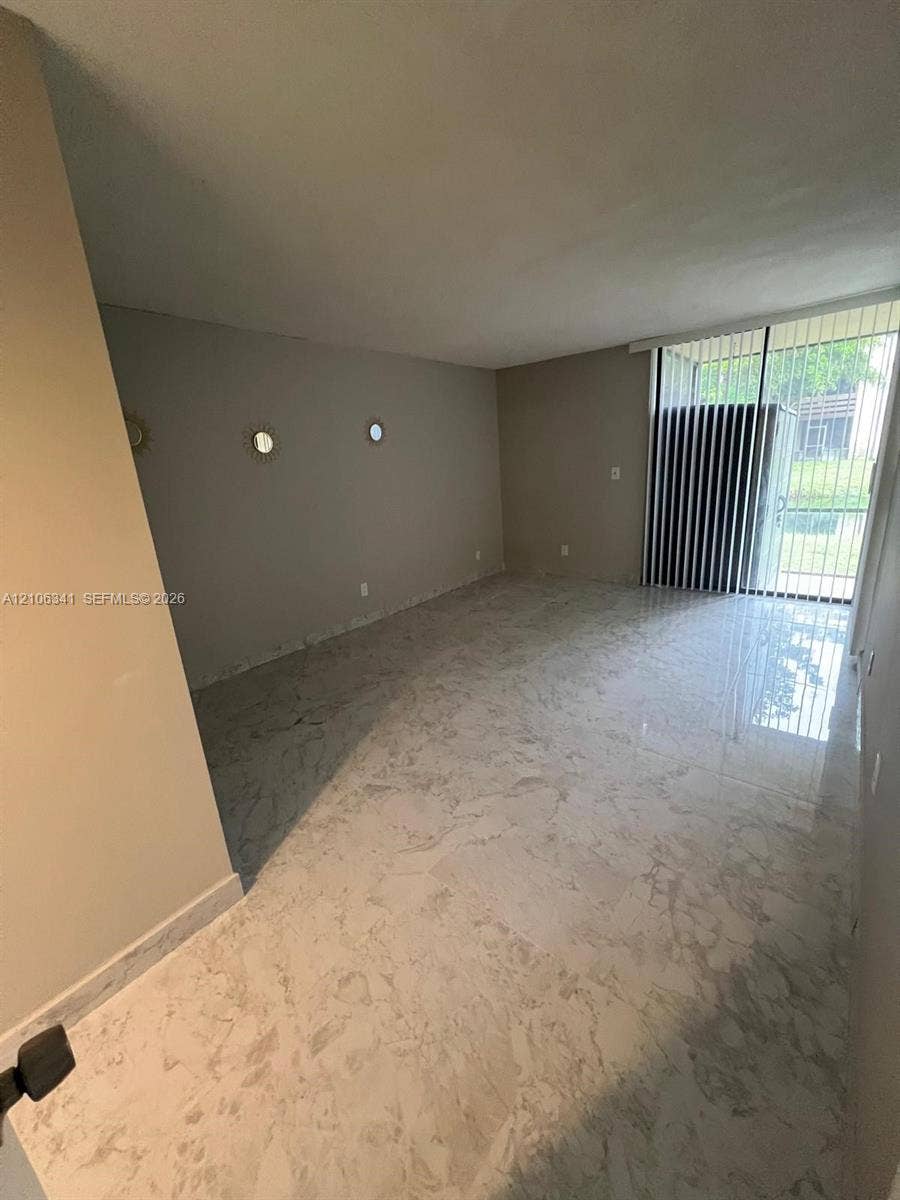 primary bedroom w full bathroom and sliders to screened porch that overlooks canal
