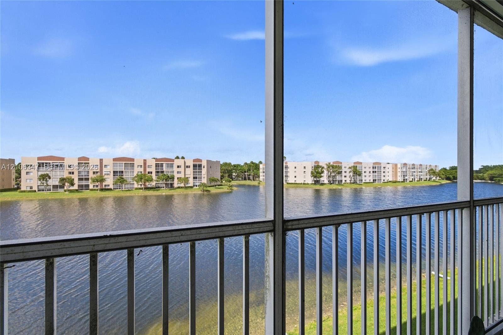 7759 Granville Drive, #306, Tamarac, FL 33321 Screened-in balcony featuring metal railing and water frontage