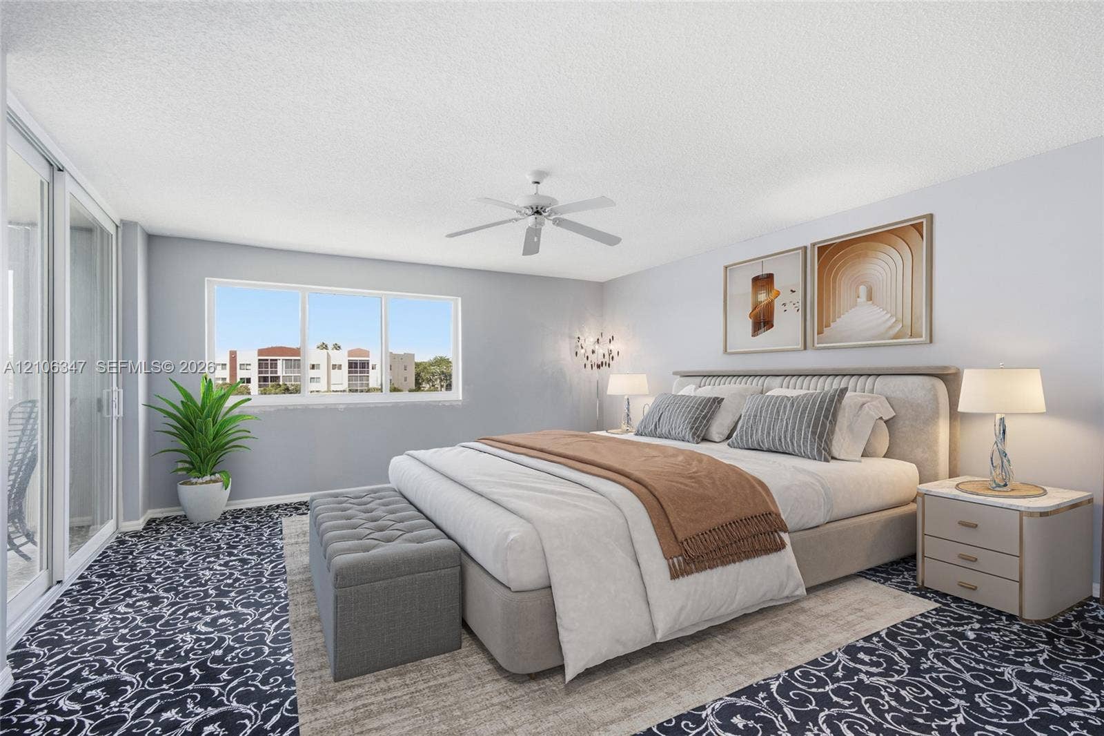7759 Granville Drive, #306, Tamarac, FL 33321 Large horizontal window, sliding glass door, white ceiling fan, and patterned textile flooring